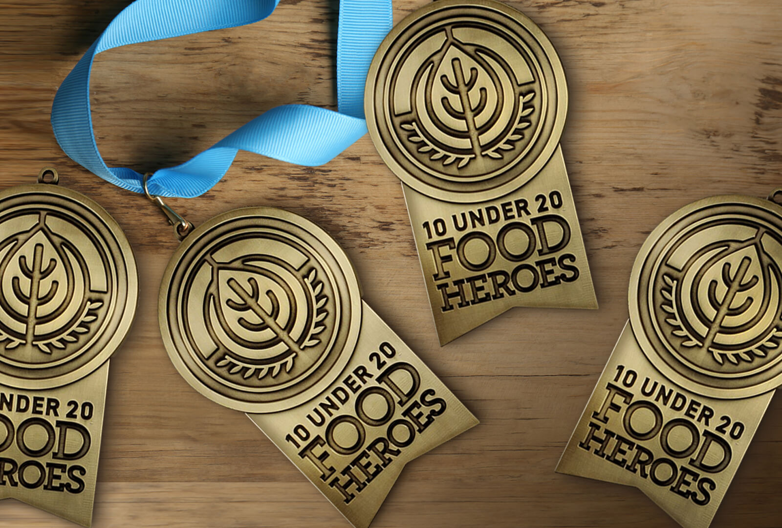 a group of award medals on a wood table