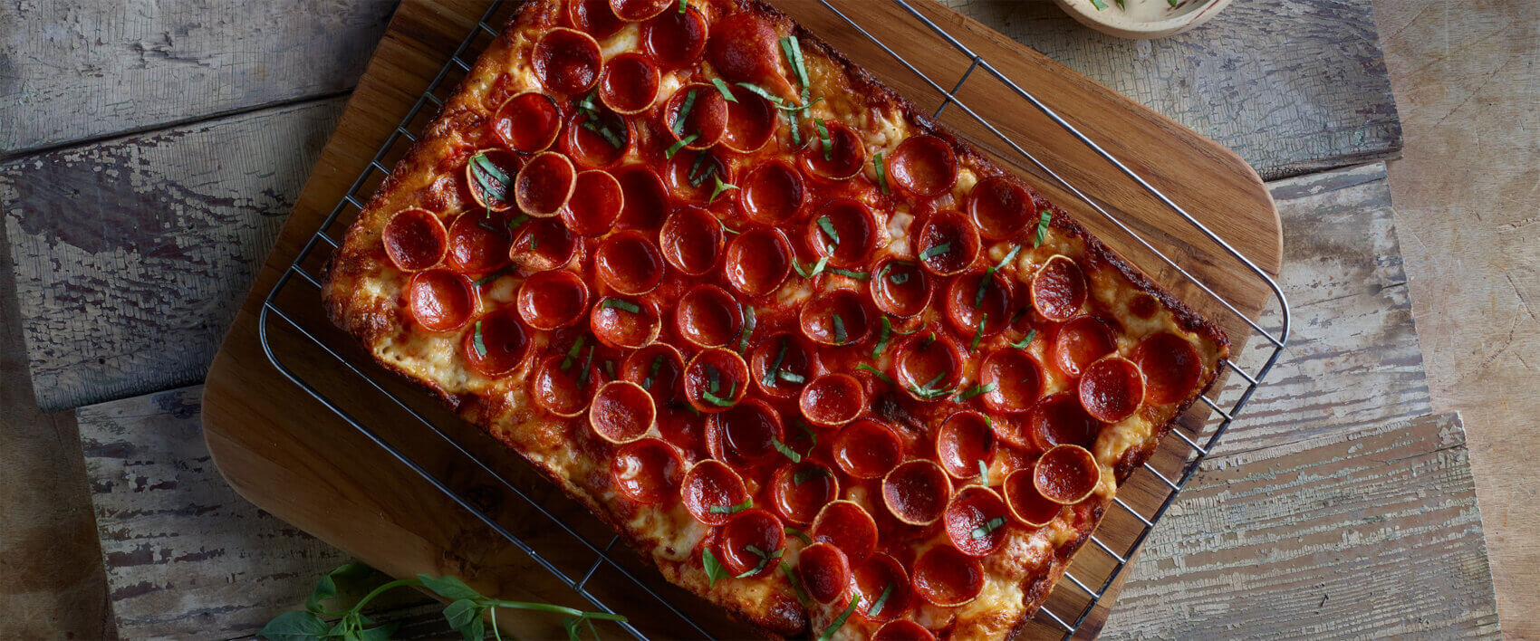 Detroit-Style Pizza with Red Curry Tomato Sauce, Pepperoni and Thai Basil - Hormel Foods