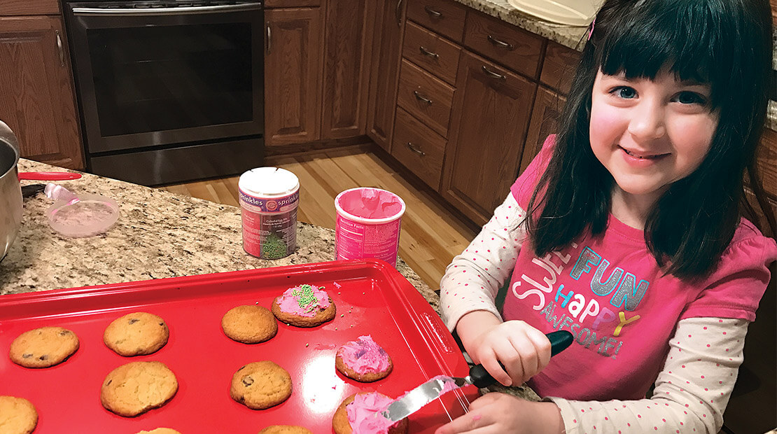 Claire Donicht frosts cookies.