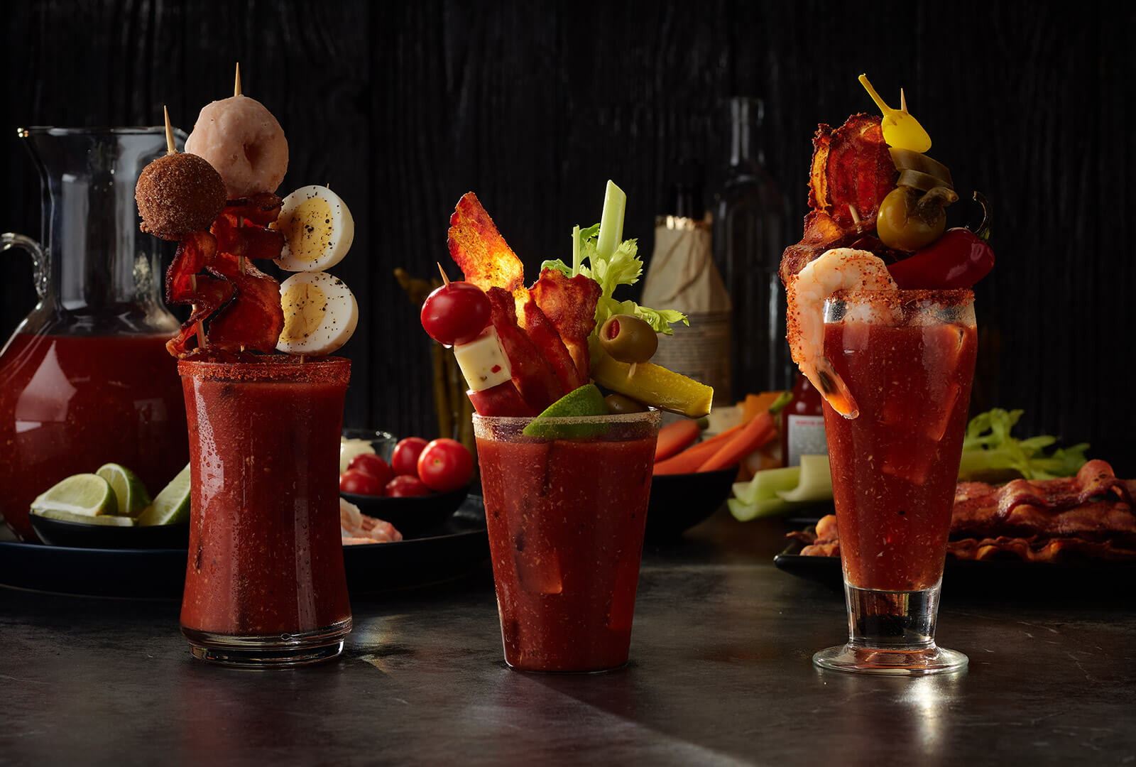 Three Bloody Mary cocktails on a tabletop