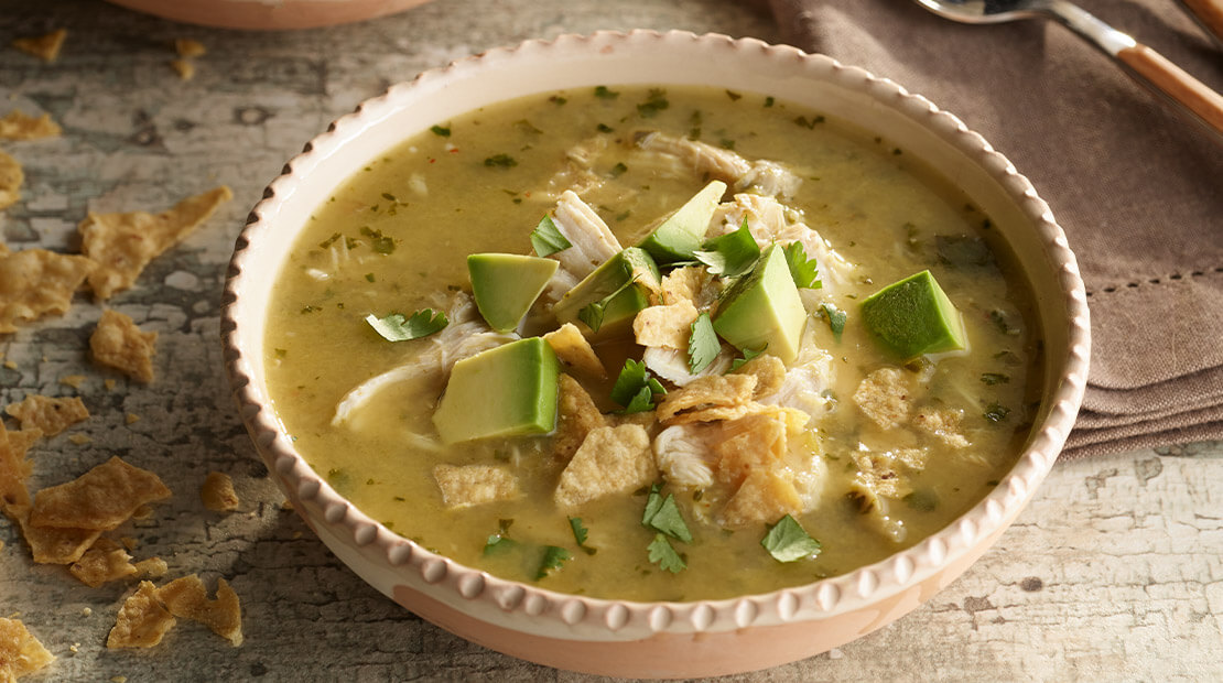 Chicken Chile Verde soup in a tan bowl