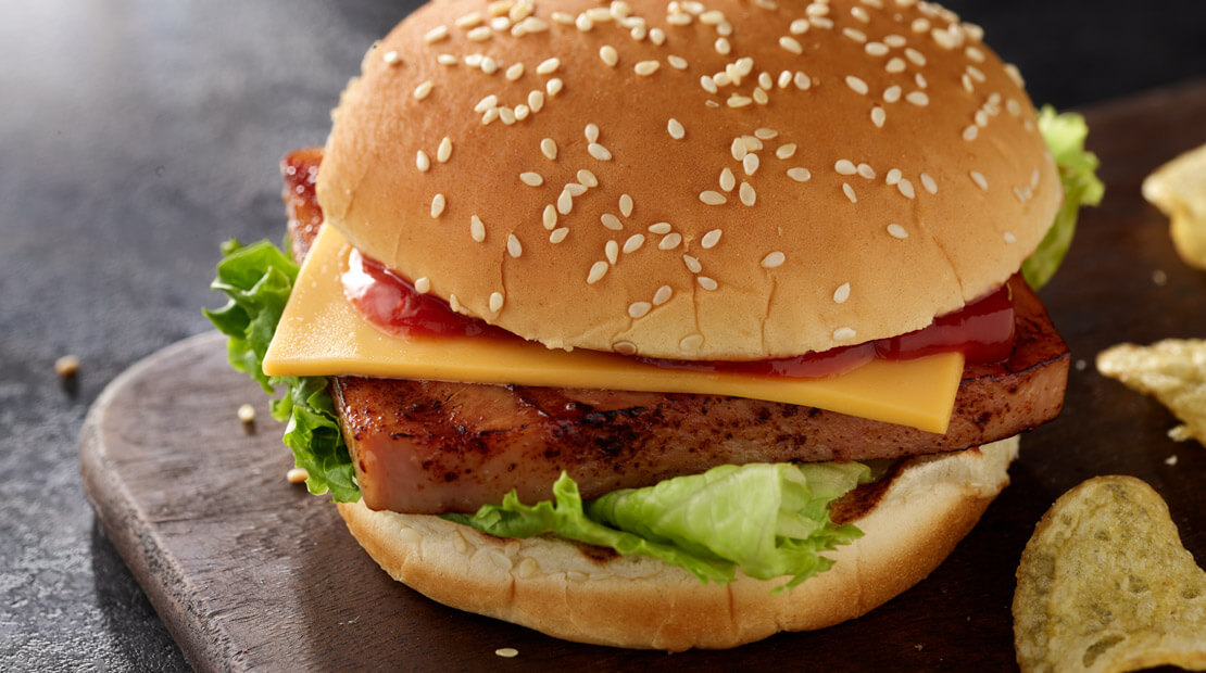 SPAMburger Hamburger on a wooden cutting board