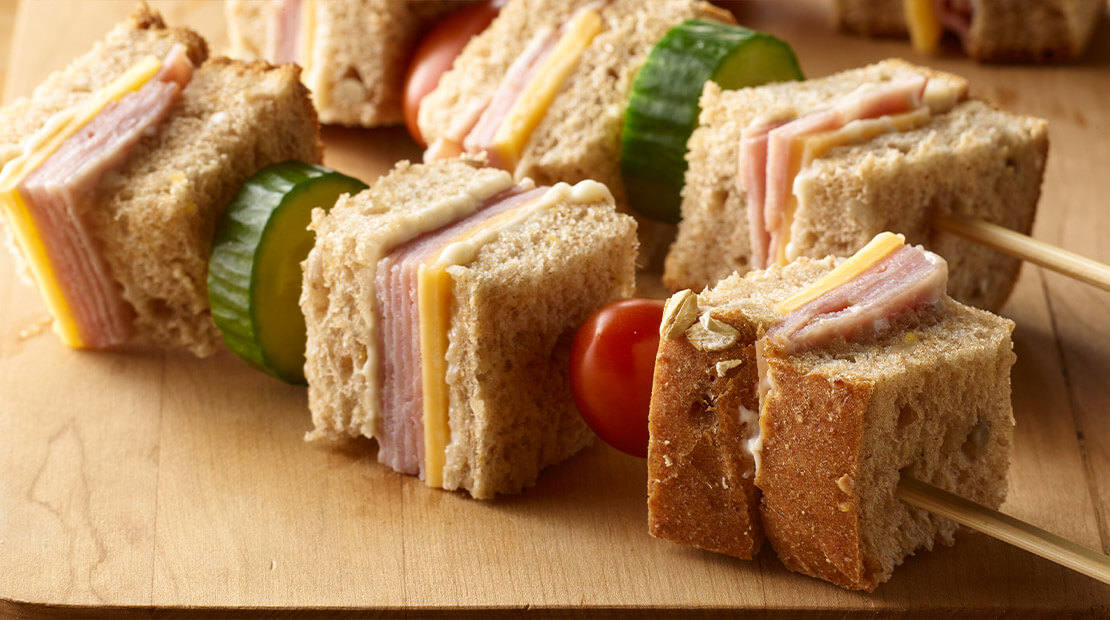 close up of sandwich served on a skewer