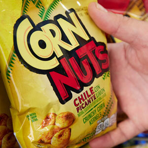 Hand picking up corn nuts