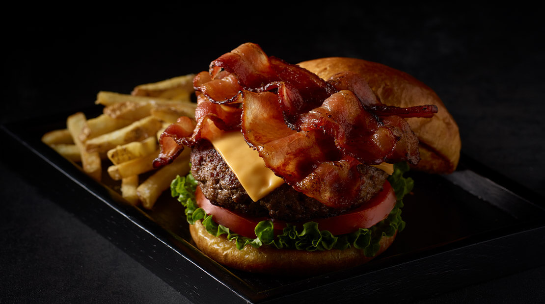 Ranch Bacon Cheese Burger on a plate with fries