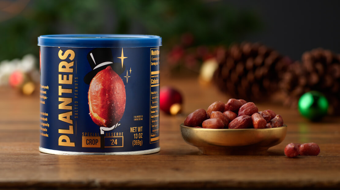 A can of PLANTERS® Special Reserve peanuts next to a small gold dish holding some of the peanuts.