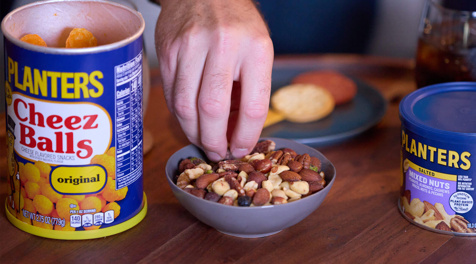 Hard reaching for mixed nuts with Planters Cheez Balls package and Planters mixed nuts package