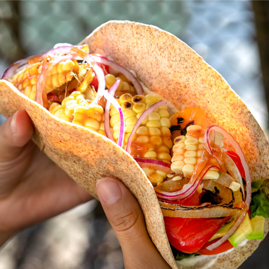 charred corn and red onion taco, technically an open-faced wrap, inside a whole wheat tortilla