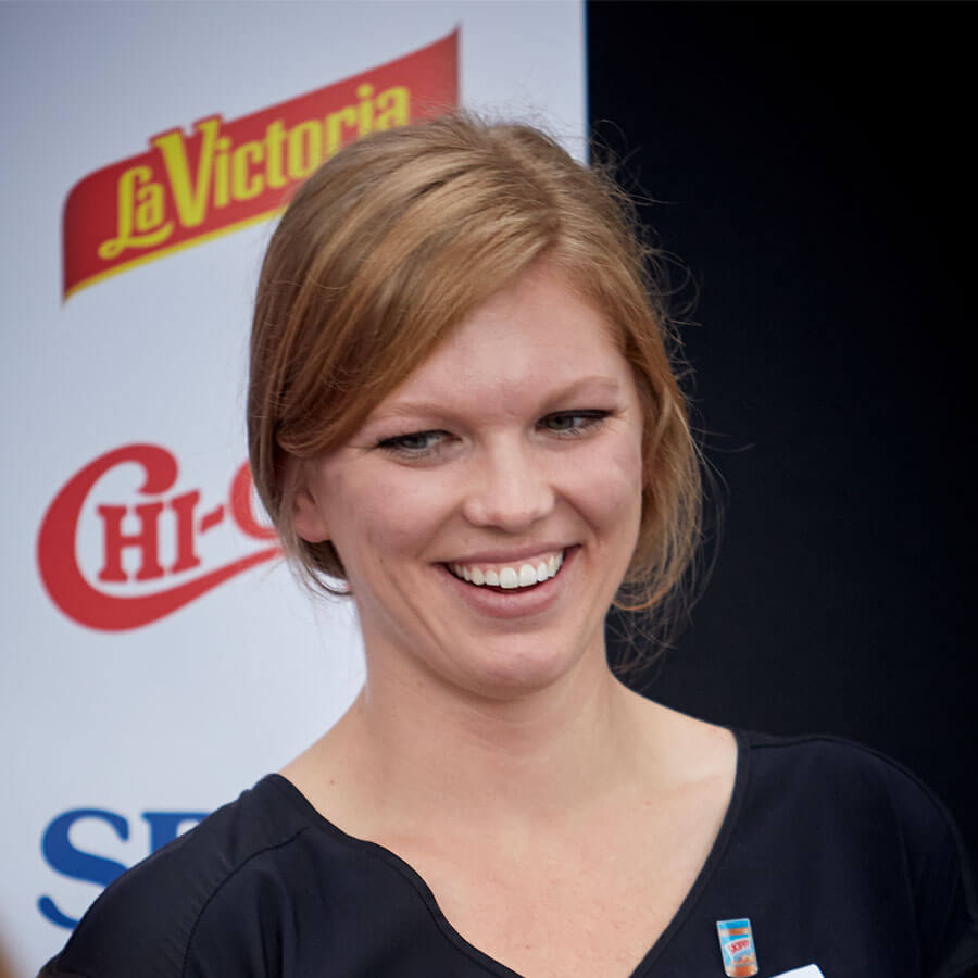 Woman with brand signage behind