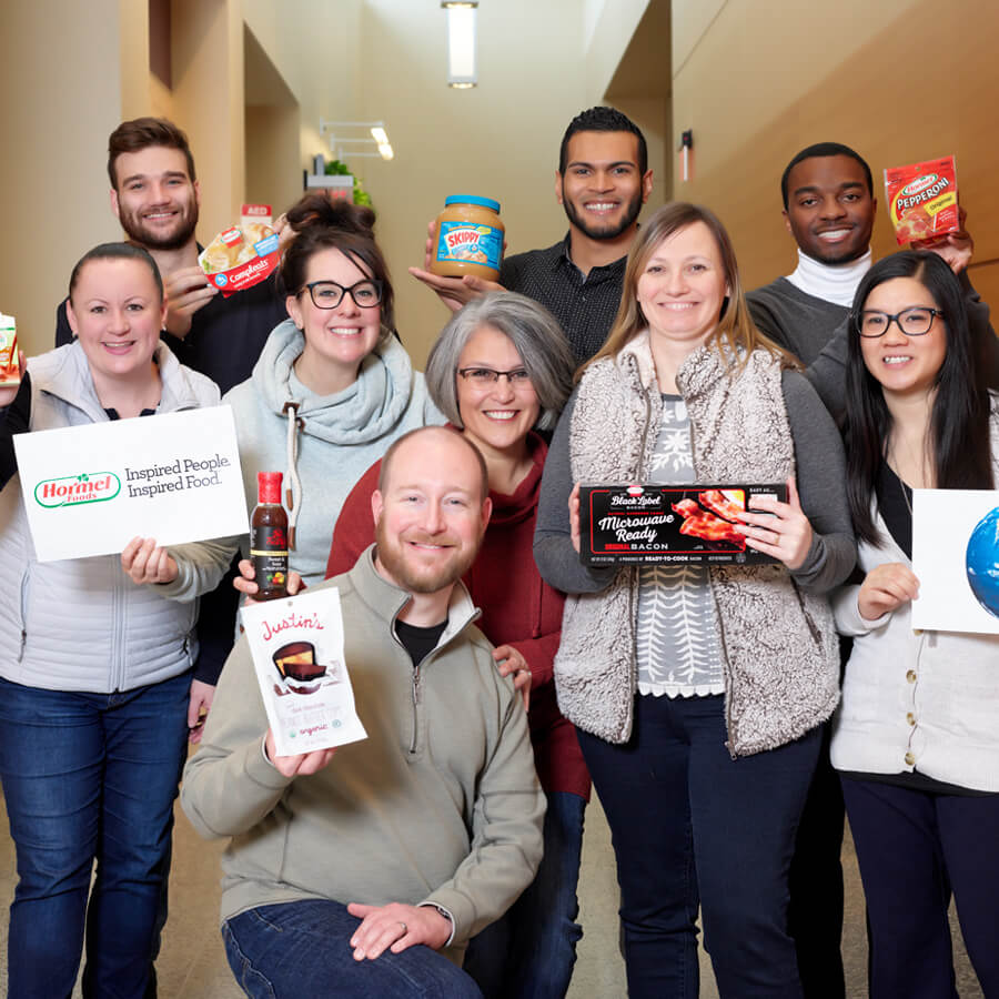 Hormel Foods employees holding a diverse set of products