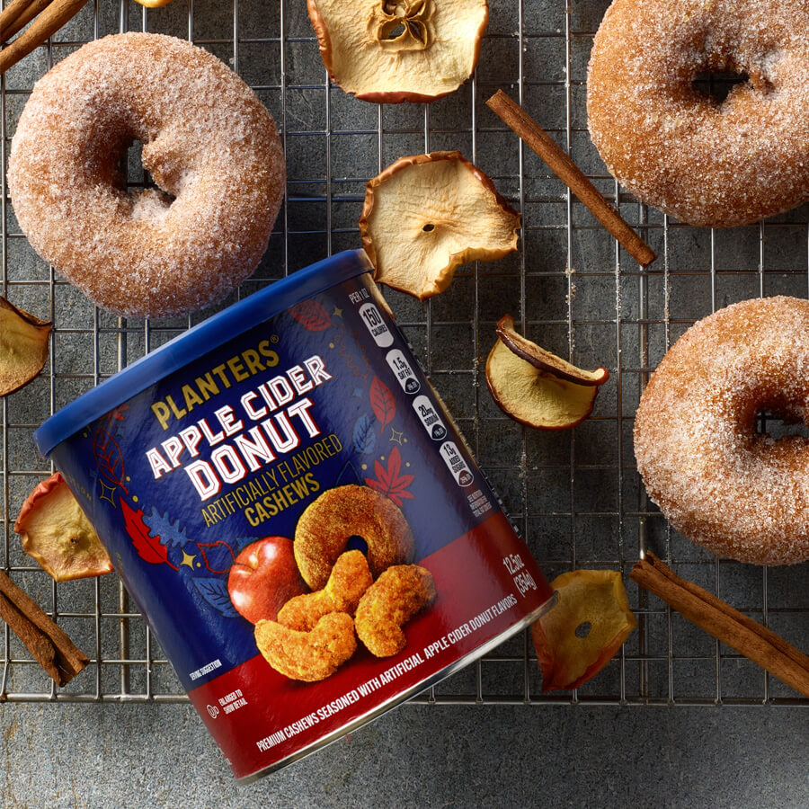 Planters Apple Cider Donut Cashews package with dried apples & cinnamon sticks