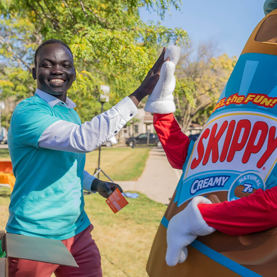 high five with skippy character at community event
