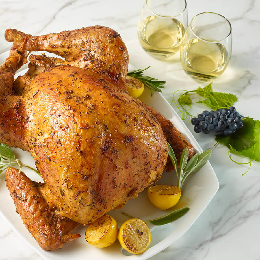 Turkey on platter with wine glasses & grapes