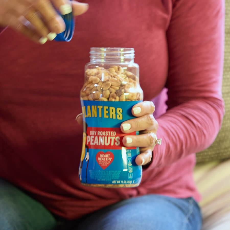 Woman holding Planters peanut jar