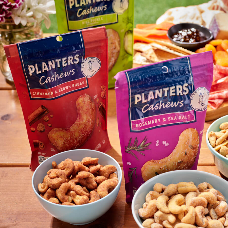 variety of Planters nuts packages with nuts in bowls