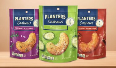 Planters rosemary and sea salt, dill pickle, and cinnamon and brown sugar cashews in their packaging on a table
