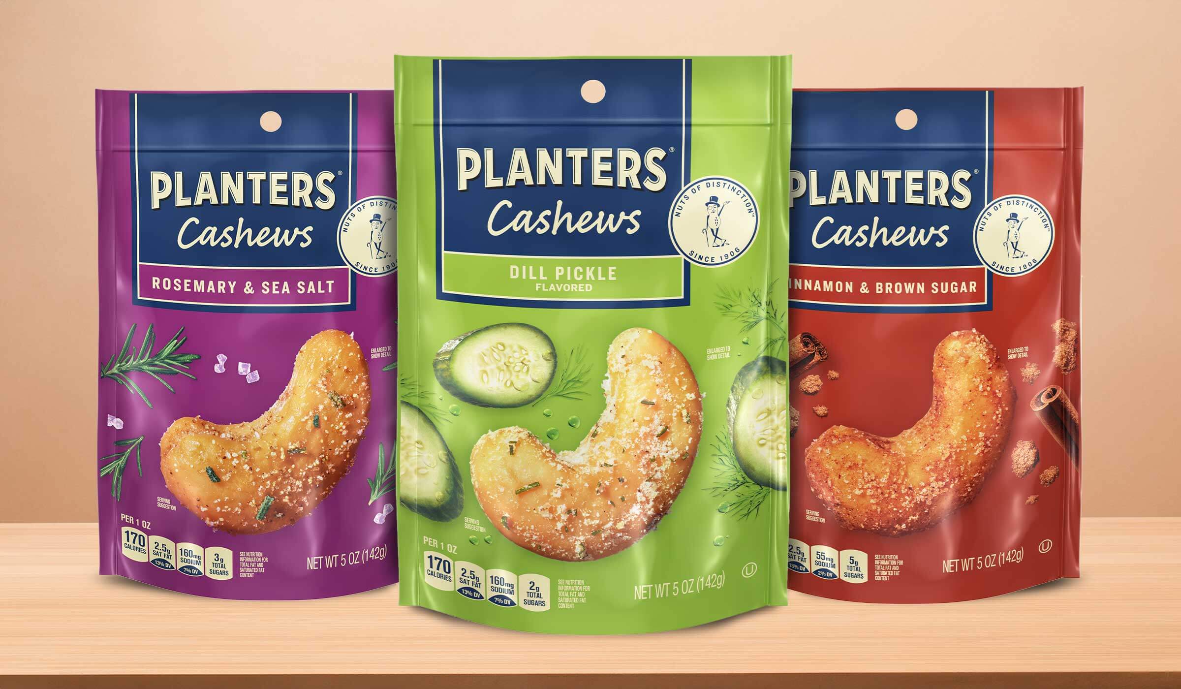 Planters rosemary and sea salt, dill pickle, and cinnamon and brown sugar cashews in their packaging on a table