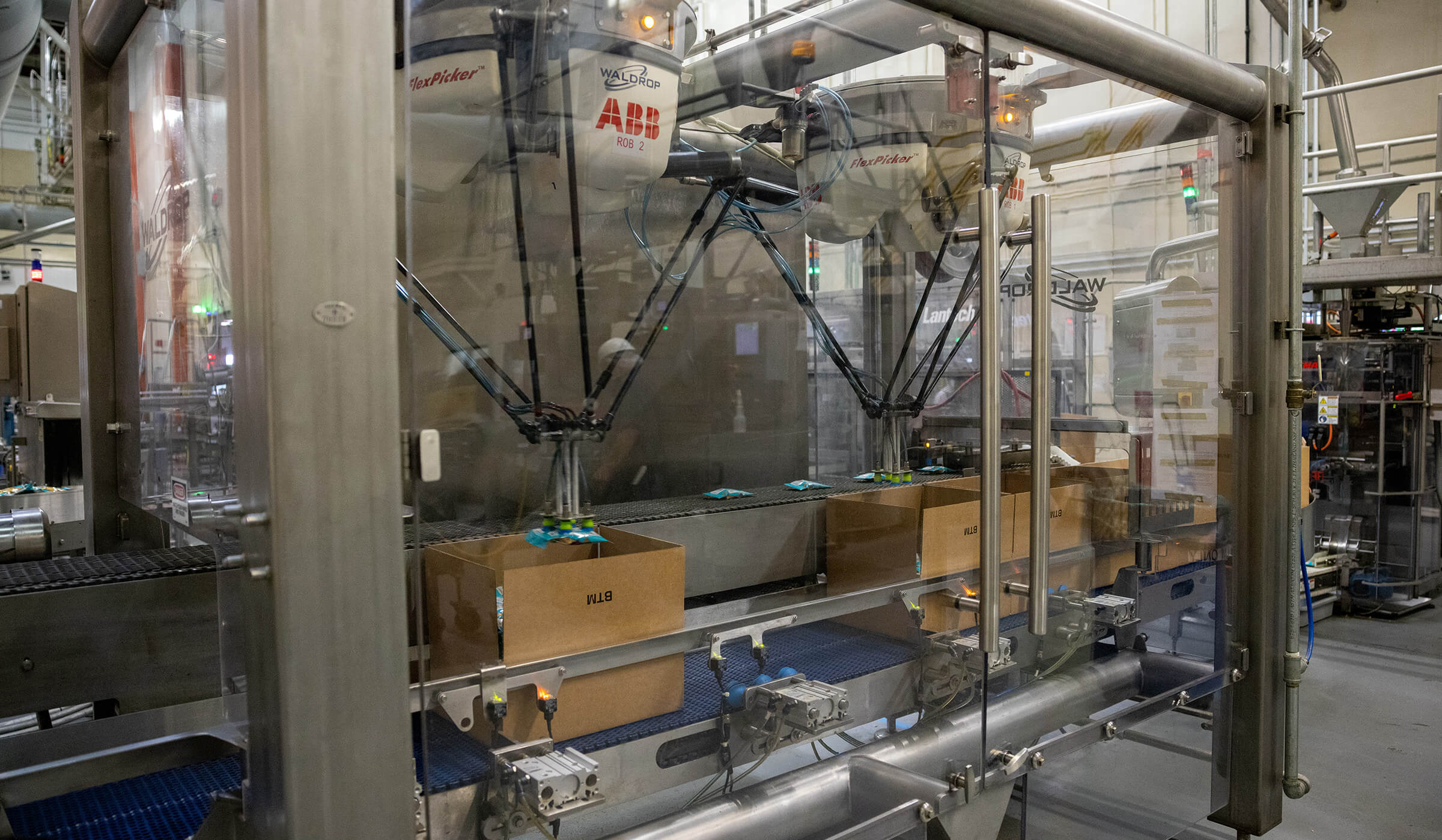 Filled bags of Corn Nuts being boxed up on their way to consumers worldwide