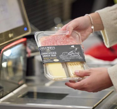 Person scanning a COLUMBUS<sup>®</sup> Charcuterie Snack Tray Genoa Salame at checkout
