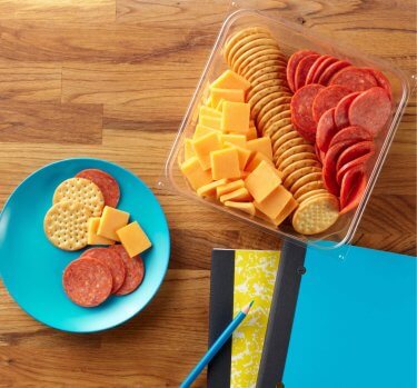 HORMEL GATHERINGS<sup>®</sup> Snack Tray on a table with notebooks