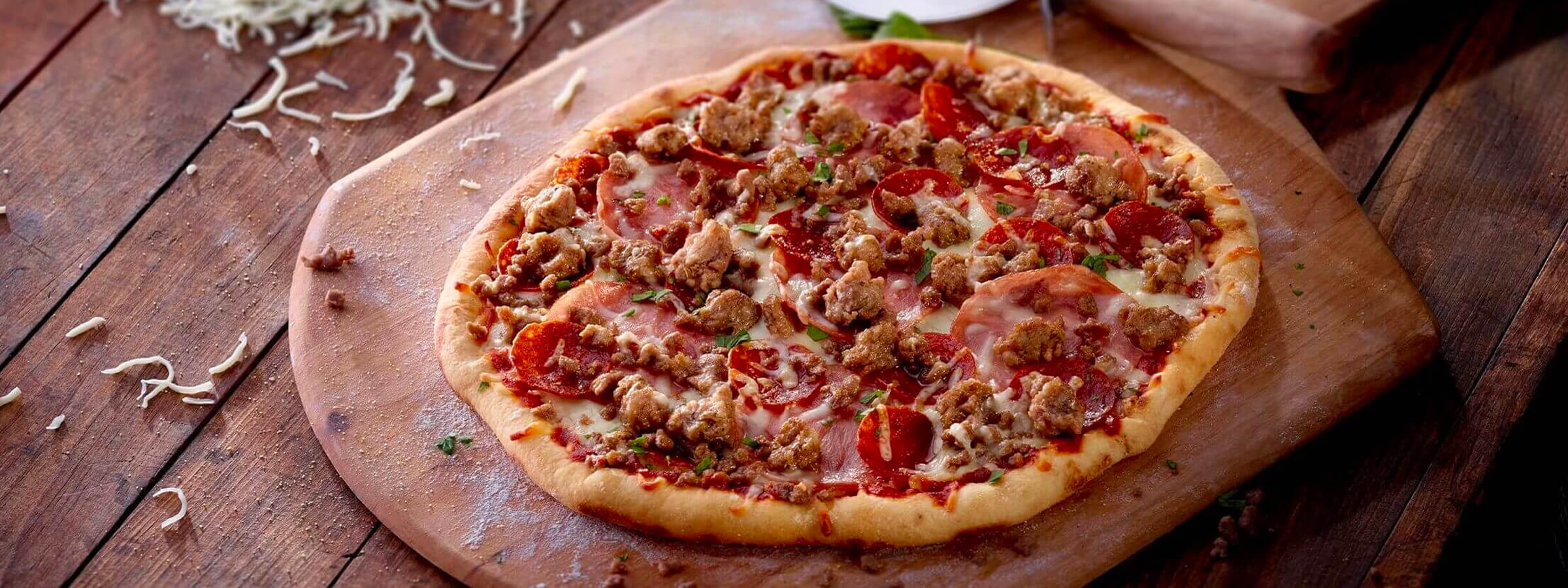 A pizza with sausage and meat