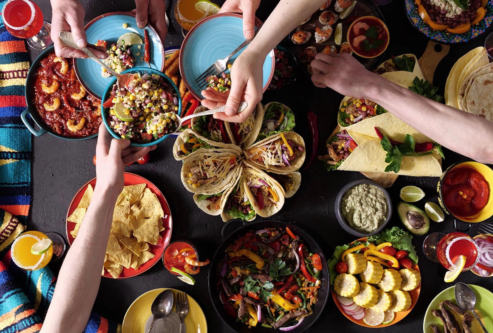 A large traditional Mexican meal people are reaching for