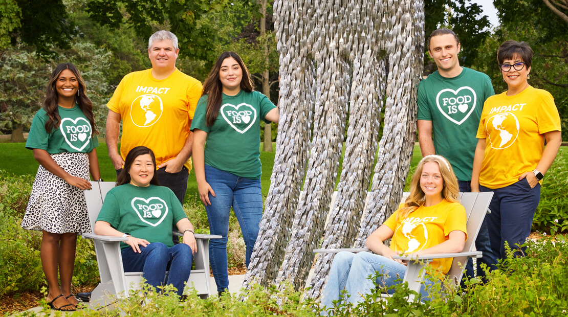 Global Impact team members surrounding The Power of Food sculpture