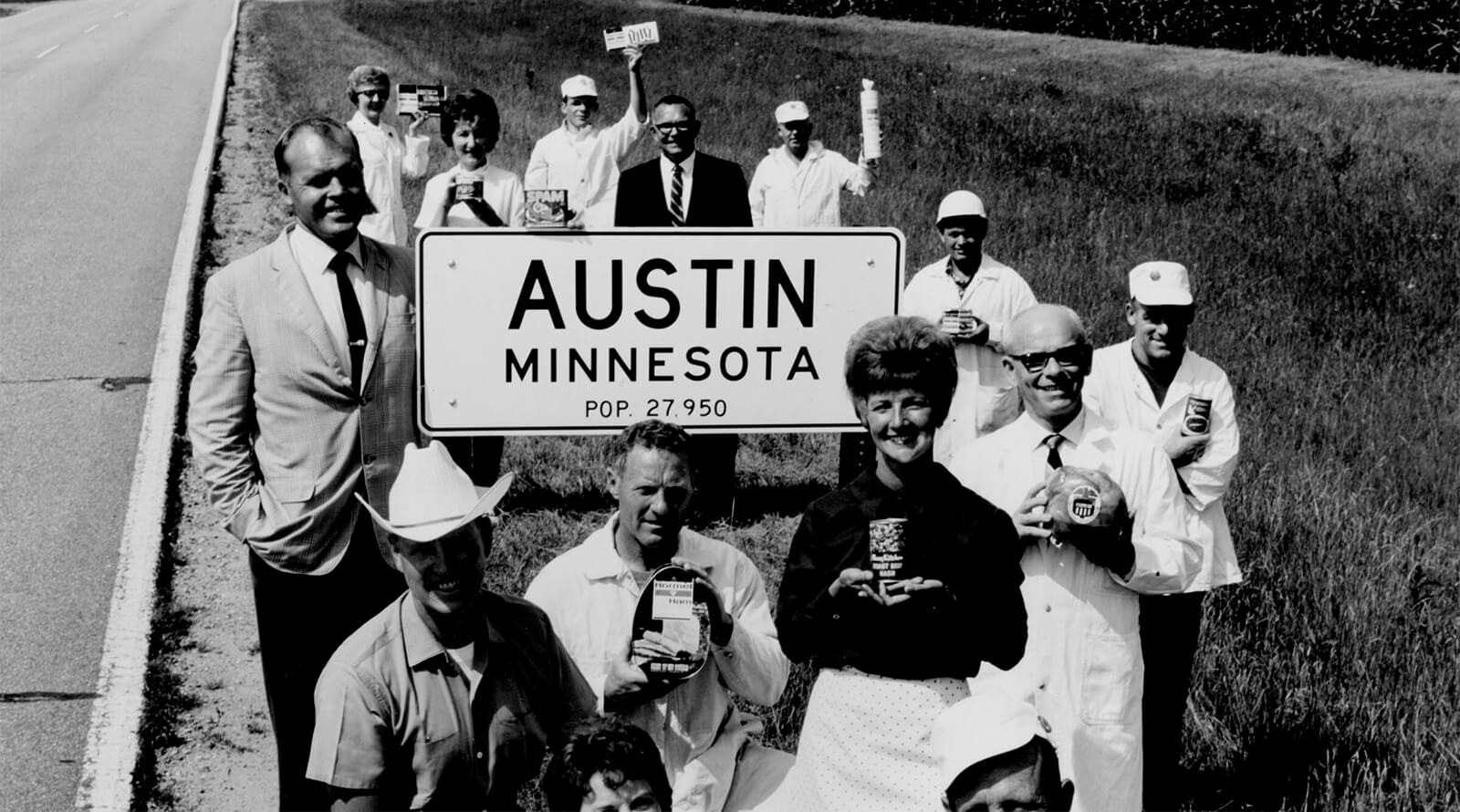 Team members with Austin MN sign and products