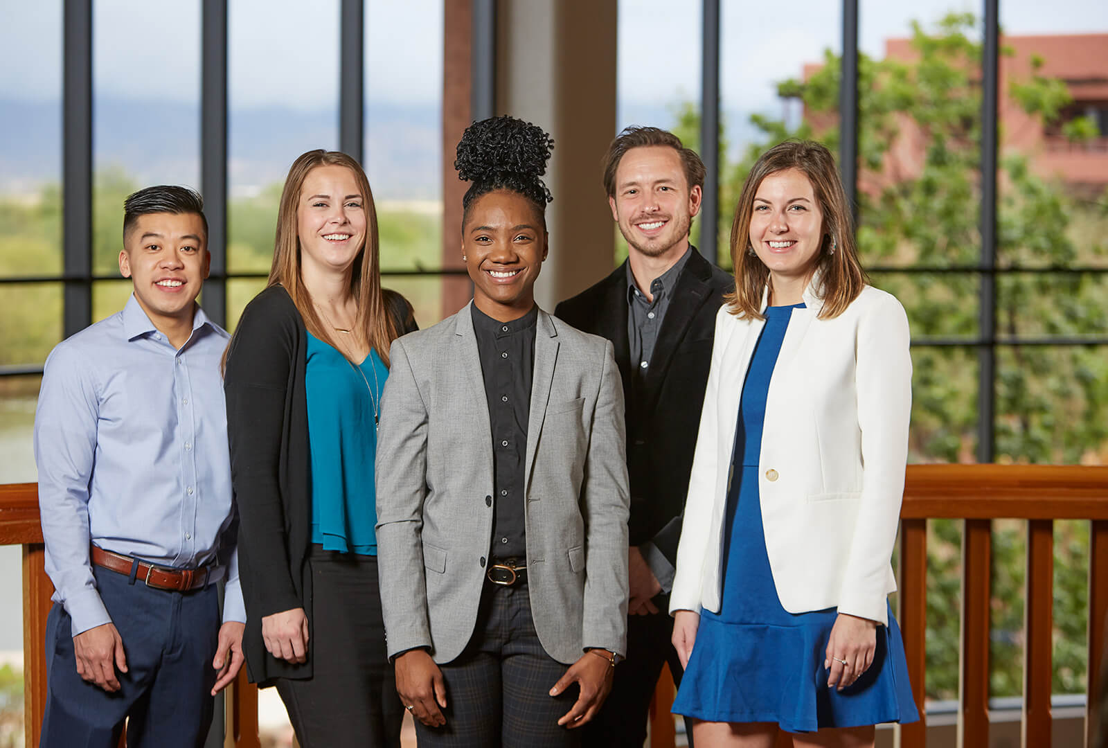 A group of interns standing together in front of a window at Hormel Foods headquarters