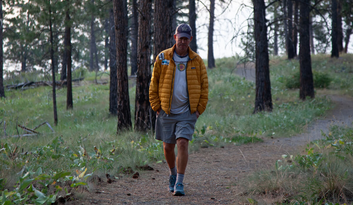 Kenneth Perry walking through the woods