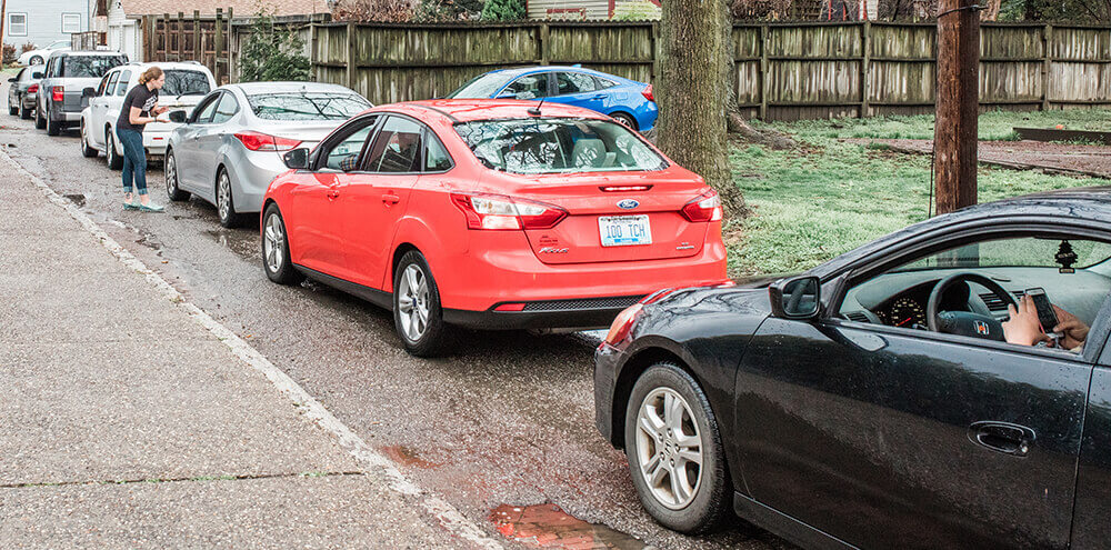 A line of cars waiting to receive to-go meals