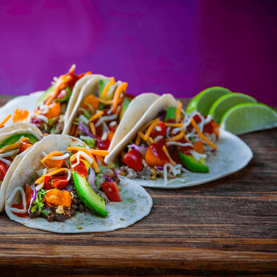 Some MegaMex tacos on a wood table