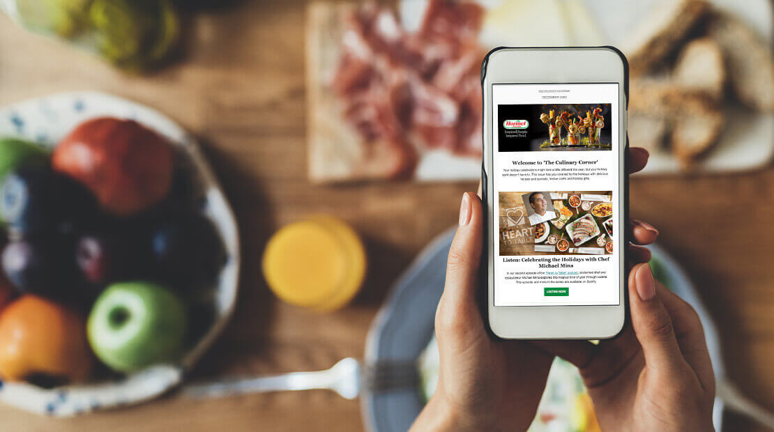 Person looking at Hormel Culinary newsletter on phone in kitchen