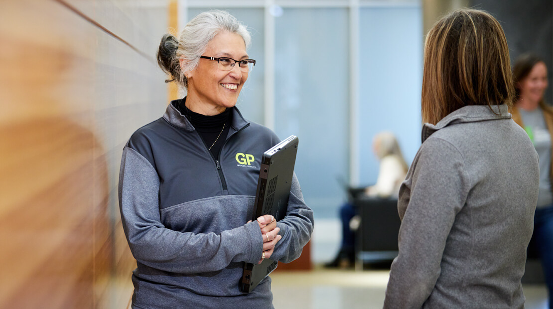 Team members in hallway conversation at World headquarters