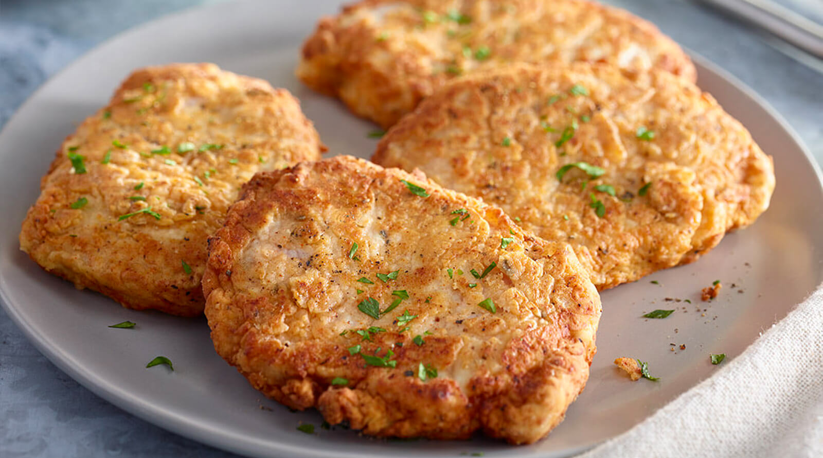 Pan fried pork chops on a plate