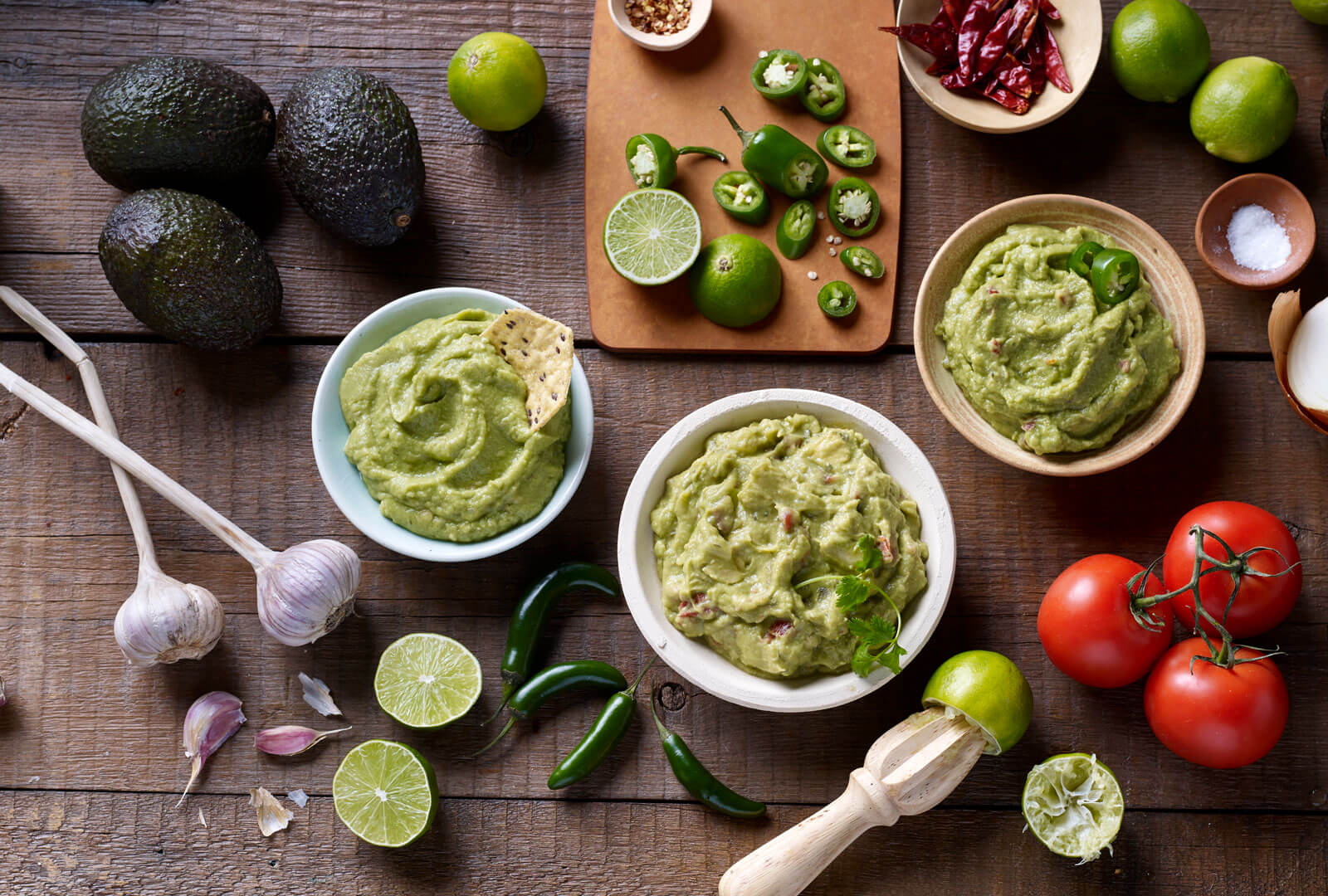 guacamole and it's ingredients laid out on a table