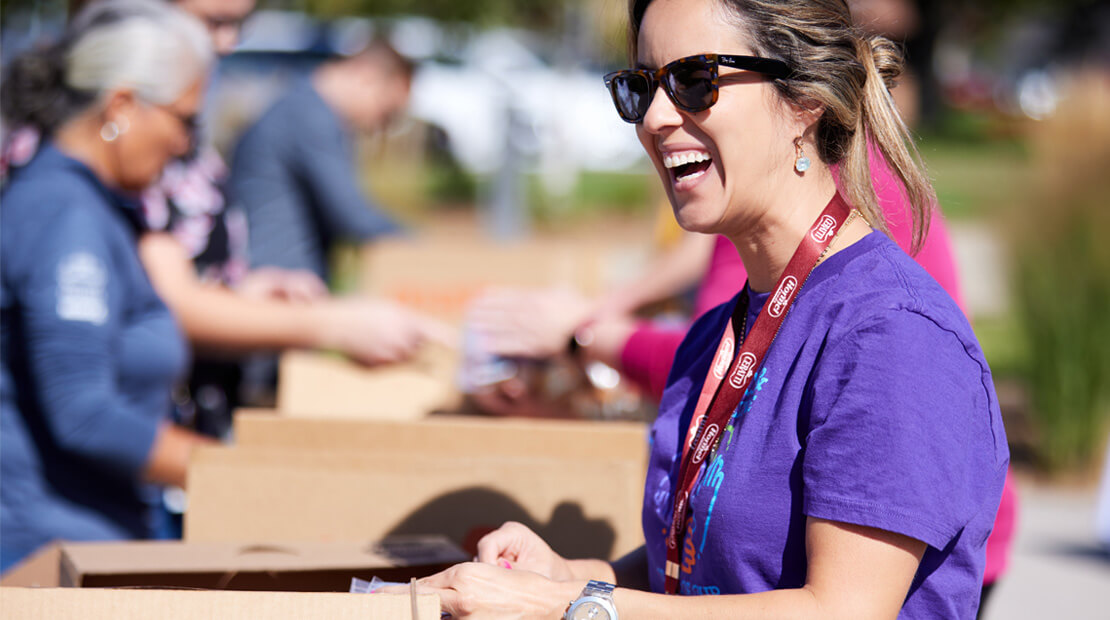 Team member laughing outside while participating in donation event